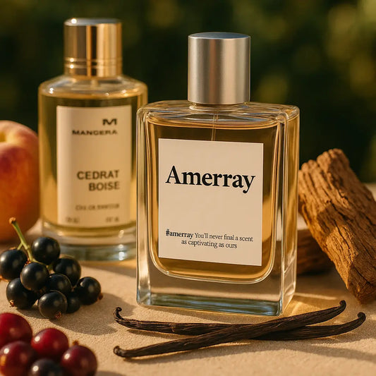 Two luxury perfume bottles displayed on a table with natural ingredients. The front bottle is labeled “Amerray” with the tagline “You’ll never find a scent as captivating as ours.” Behind it is a bottle of Mancera Cedrat Boise. Around them are blackcurrants, vanilla pods, wood, and an apple, symbolizing the fragrance notes.